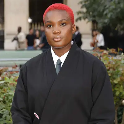 Arlo Parks with fiery red buzzed hair at the Kenzo Menswear Spring/Summer 2025 show in Paris, France