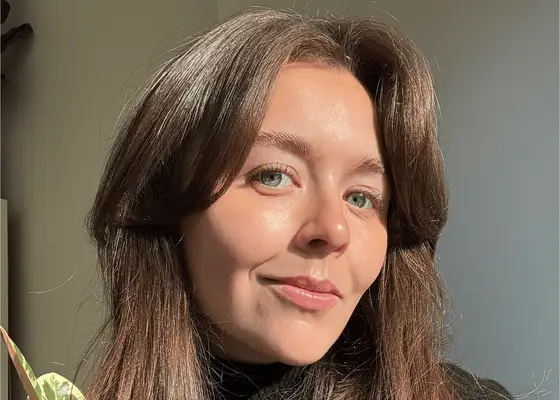 woman with curtain bangs taking selfie in sunlight 