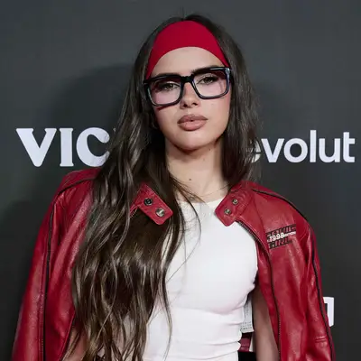 Mar Lucas wearing dark thick glasses with bright red headband