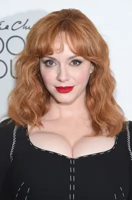Christina Hendricks with curtain bangs and medium-length hair
