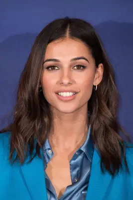 Naomi Scott with medium-length hair tucked behind ears