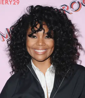 Gabrielle Union with curly shoulder-length hair and bangs