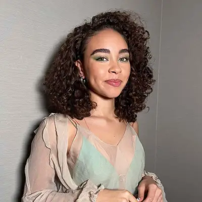 Bailey Bass with brown curly hair