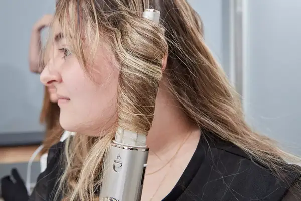 Person curling their hair with the Shark FlexStyle Air Styling and Drying System