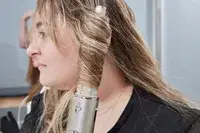 Person curling their hair with the Shark FlexStyle Air Styling and Drying System