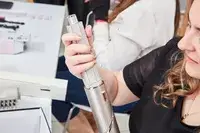 Person adding an attachment to the Shark FlexStyle Air Styling and Drying System