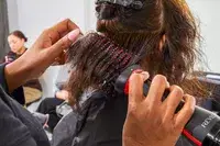 Closeup of hands styling hair using Revlon One-Step Volumizer Plus 2.0 Hair Dryer and Hot Air Brush