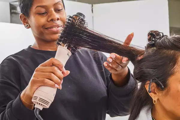 Stylist brushing a person