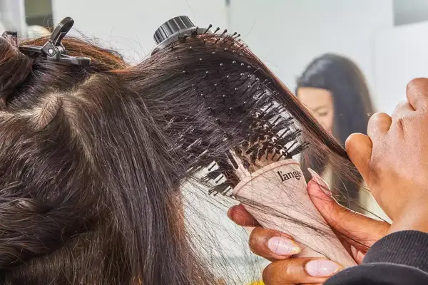 Hands brushing a person