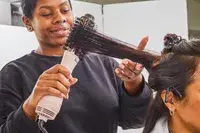 Stylist brushing a person