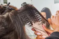 Hands brushing a person