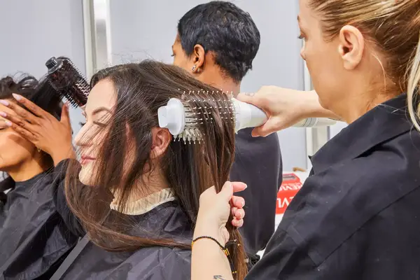 Stylist brushing a person