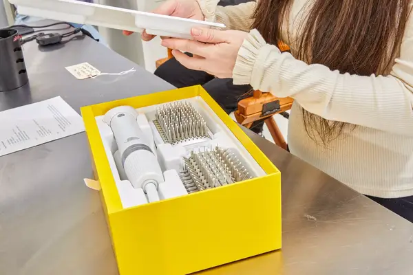 Person opening the box of the Drybar Reserve 3-In-1 Interchangeable Blow Dryer