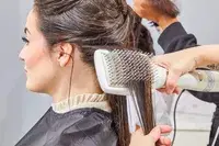 Wet hair being brushed with the Drybar Reserve 3-In-1 Interchangeable Blow Dryer