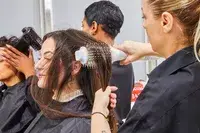 Stylist brushing a person