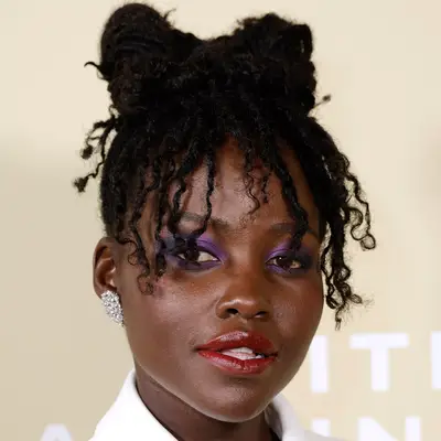 Selena Gomez wears a wavy bob hairstyle with bangs