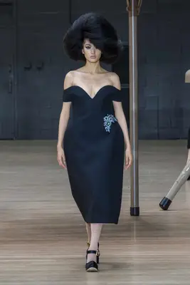 Model at the Marc Jacobs show wearing big hair and a black dress