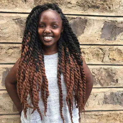 Woman with long Havana twists with lighter woven extensions