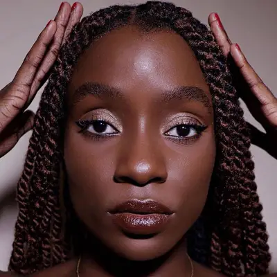 Close-up of woman with two-toned Havana twists and shimmery neutral makeup
