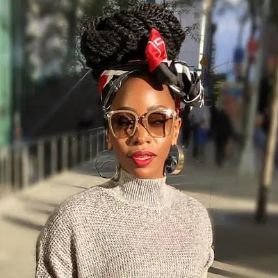 Teyonah Parris wears a Havana twists updo with scarf and sunglasses