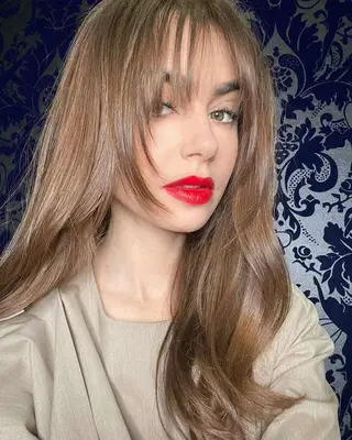 Lily Collins glossy light brown hair with face-framing bangs