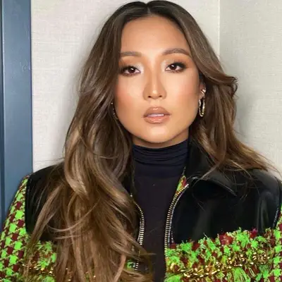 Ashley Park with cool brunette balayage hair