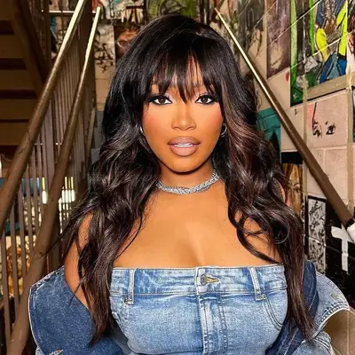 Keke Palmer with full fringe and black and brown highlighted hair