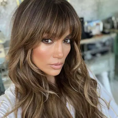 Jennifer Lopez with full fringe and brown and blonde balayage hair