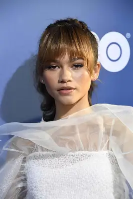 Zendaya with bardot bangs and an updo
