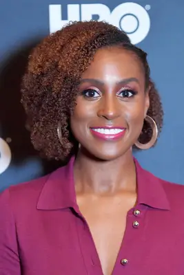 Issa Rae with side parted layered natural curls