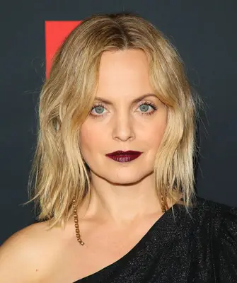 Mena Suvari with a wavy middle parted lob and deep purple lips