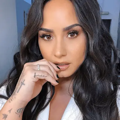 Demi Lovato with face framing layered wavy hair