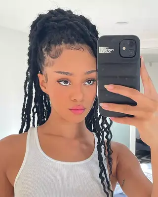 Manon of Katseye with faux locs