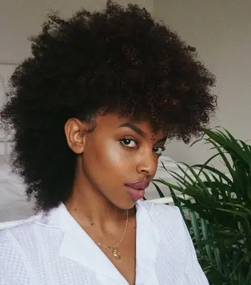 Woman with kinky-curly voluminous frohawk