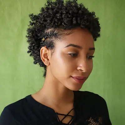Curly frohawk with side braids