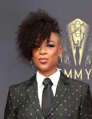 Samira Wiley wearing a super curly frohawk