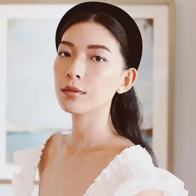 Woman with black velvet headband and fresh makeup look