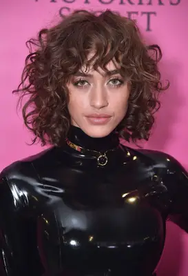 Alanna Arrington with a curly shag hairstyle and bangs