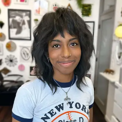 A person with a wispy shag hairstyle