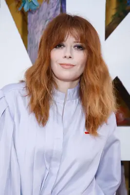 Natasha Lyonne with a long shaggy hairstyle and bangs