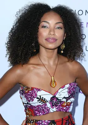 Logan Browning with a curly shag hairstyle
