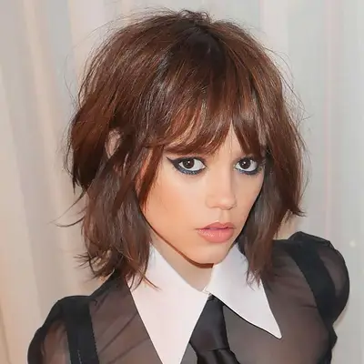 Jenna Ortega with a shaggy short wolf cut