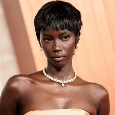 Anok Yai with a choppy pixie shag hairstyle