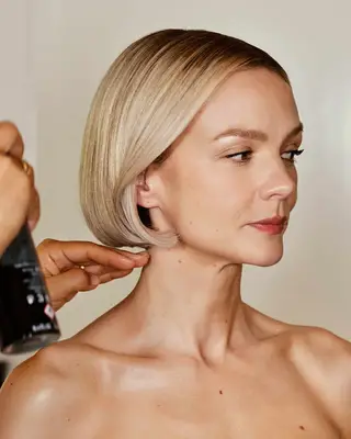 Actor Carey Mulligan getting her hair sprayed