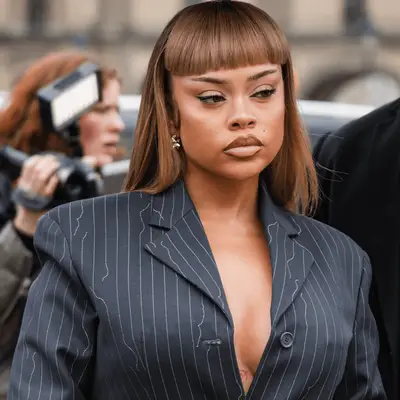 PARIS, FRANCE - FEBRUARY 29: Alyssa Michelle Stephens wears grey striped blazer with matching mini skirt, silver bag, outside Off-White, during the Womenswear Fall/Winter 2024/2025 as part of Paris Fashion Week on February 29, 2024 in Paris, France. (Photo by Claudio Lavenia/Getty Images)