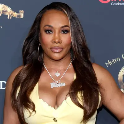 vivica a. fox wearing loose curls with face-framing highlights