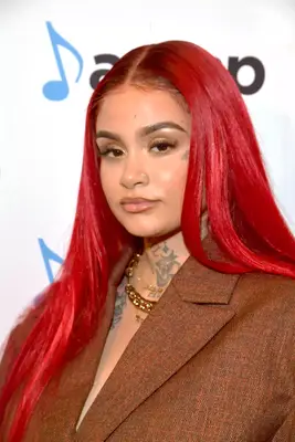 Kehlani wearing long, sleek red hair
