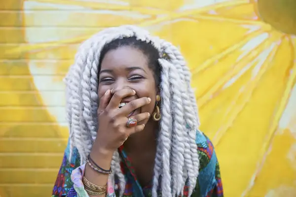 woman laughing wearing crochet braids
