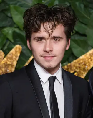 Brooklyn Beckham with wavy bangs 