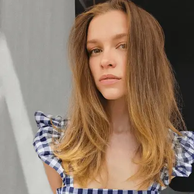 Actress Sophie Cookson with warm honey blonde hair.